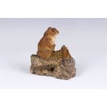 Edmund Blampied R.E, R.B.A. (Jersey, 1886-1966), A HareClay maquette, seated on a stone and signed