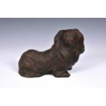 A Pekingese dog figure or doorstop, 12in. (30.5cm.) long.