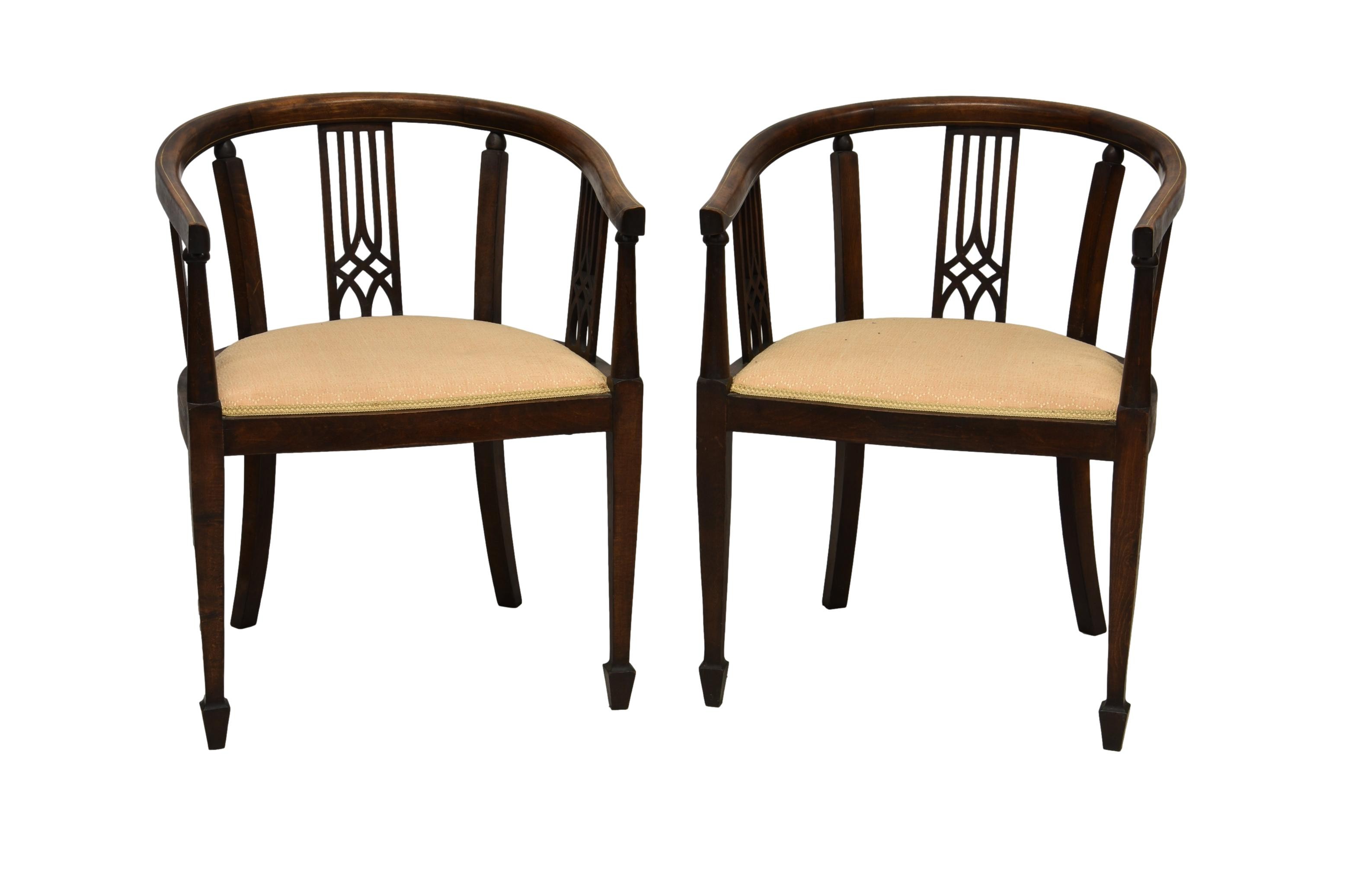 A pair of Edwardian strung mahogany tub chairs, the top rail with boxwood stringing over a pierced