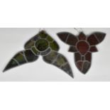 Two early 20th century leaded glass elements from a stained glass window, each with central motif