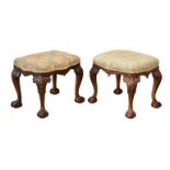 A pair of Queen Anne style serpentine stools, with serpentine stuff over seats on carved cabriole
