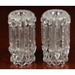 A pair of Victorian clear glass table lustres, each having flower head to tapering hexagonal