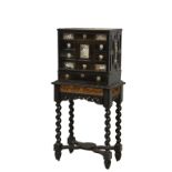 A late 17th or early 18th century ebony cabinet with silver mounts, probably German, on a later