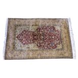 An Imperial Jewel silk Herati prayer rug, the Mihrab on a madder ground with Herati spandrels and