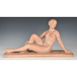 Henri Bargas - a terracotta figure of a reclining nude, 1920s-30s, with her right leg drawn up,
