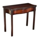 An early George III fiddleback mahogany serpentine tea table, with good colour, gateleg mechanism,