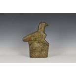 A Zimbabwe carved stone bird sculpture, the stylised bird standing upon a Aztec style base, 14in. (