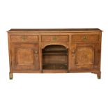 A 19th century oak dresser base, the rectangular top over three draws with solid plate handles, over