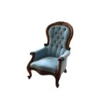 A Victorian style mahogany showframe armchair, the crested top rail over an upholstered button