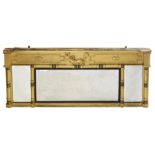 A Regency giltwood and ebonised overmantel mirror, the flared, hollow cornice over a dolphin and