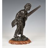A Meiji period Japanese bronze figure of a lady with a folded umbrella, dark brown patination,