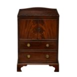A George III mahogany bedside night table cabinet, the tray top with wavy gallery, over a two-door
