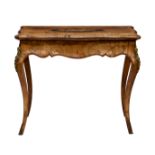 A 19th century French serpentine walnut fold over card table, the crossbanded top with inlaid floral