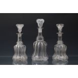 A pair of Victorian glass bell decanters, the pillar moulded bodies with polished pontils, below