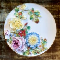 A late Victorian porcelain wall plaque of dished circular form, possibly Moore Brothers, richly