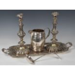 A pair of large silver plated table candlesticks, marked 'Sheffield Plate', with foliate scroll