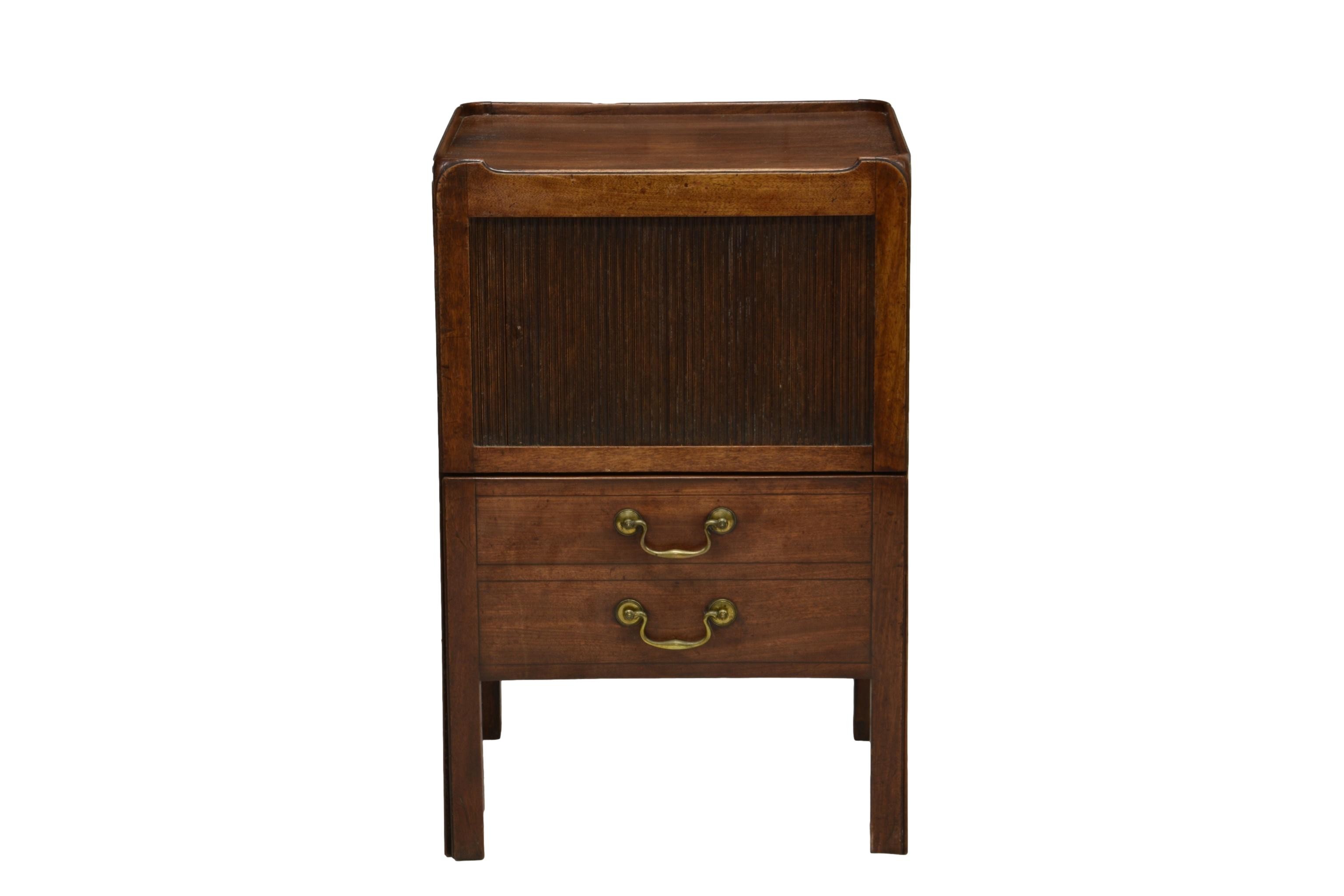 A George III mahogany tambour front tray top night table, the ¾ gallery top over a tambour front