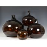 A closely matched, graduated set of four blown glass onion wine flagons, probably 19th century