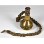 An unusual 18th century heavy brass flask with twin loops and cord, extensively inscribed in an 18th