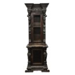 A Bavarian, late 19th century, dark oak glazed cupboard, profusely carved in the baroque revival