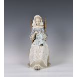 A large Lladro figurine 'embroiderer', woman modelled sitting doing embroidery, printed and