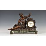 A French bronzed spelter and marble mantel clock, late 19th century, the figure of a seated female