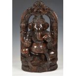 A large Indian carved hardwood figure of the Hindu deity Ganesha, 20th century, seated on a lotus