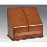 A late 19th / early 20th century oak desk tidy, with two fold out doors and a single pull out