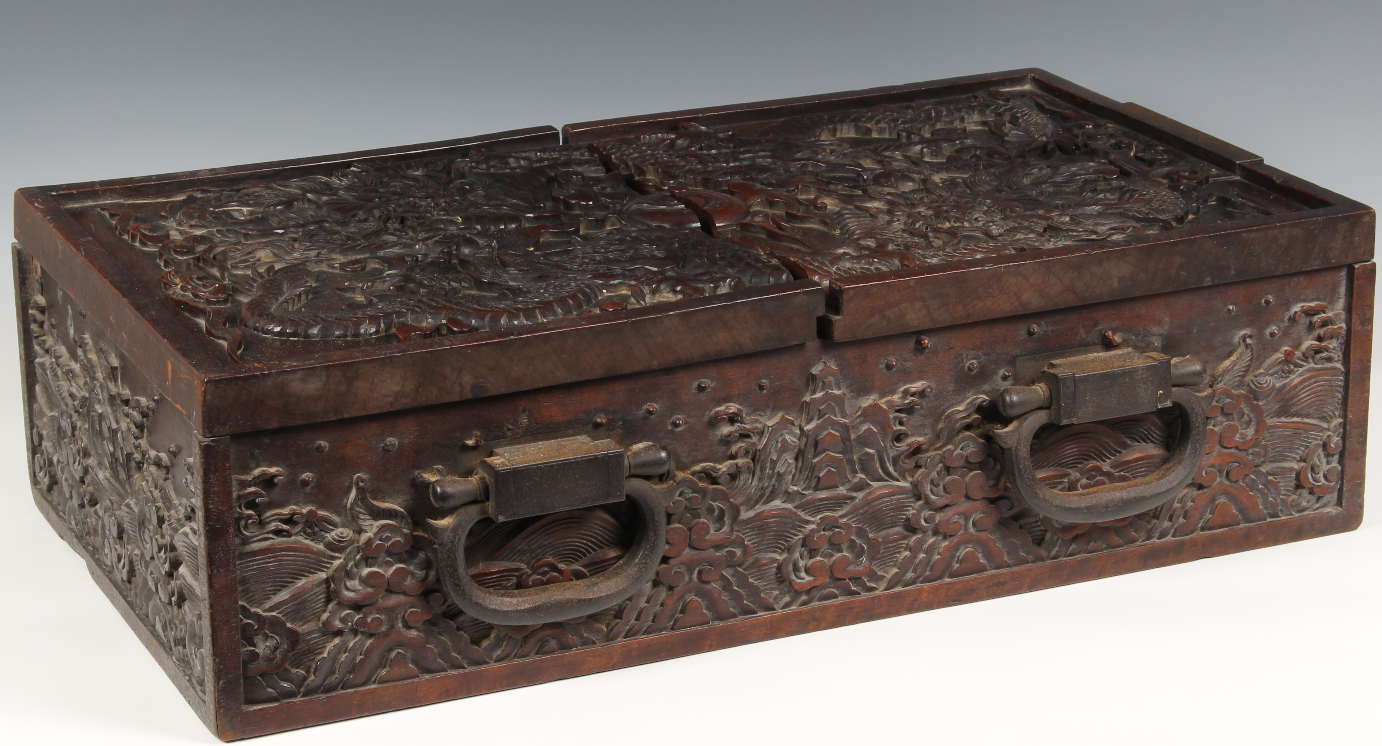 A Chinese carved teak document/writing box with iron furniture, probably 19th century, the two