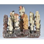 A Chinese carved soapstone group of the nine Taoist immortals, 20th century, standing upon a base of