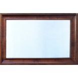 An early 18th century and later walnut mirror, the bevelled plate within a rectangular, walnut