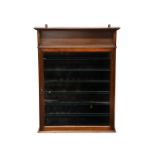 A mahogany glass fronted wall mounted display cabinet, the flared top over an open shelf and a