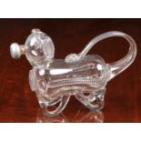 A late 19th century novelty glass decanter fashioned as a dog, his tail forming the handle and