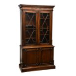 A reproduction late Georgian / early Victorian style mahogany glazed library bookcase, the flared