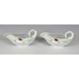 A pair of Worcester porcelain lettuce leaf sauce boats, probably first period, with moulded leaf