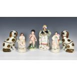 A collection of Staffordshire Pottery figures, to include a figure of young Bacchus sitting on