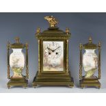 A French brass and earthenware three piece mantel clock garniture, late 19th century, the Arabic
