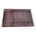 A Tekke Turkmen rug, on a madder ground with five rows of twenty Guls to the main field, with