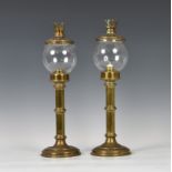 A pair of brass campaign style travelling candle lamps by Sherwood Ltd. of Birmingham, first quarter