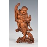 A finely carved Chinese boxwood figure of Liu Hai, probably 19th century, the rotund figure in an