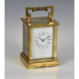 A French gilt brass carriage clock, early 20th century, signed to the white, Roman enamel dial by