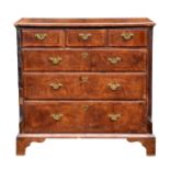 A George I and later cross banded walnut six drawer chest, the later quarter veneered burr walnut