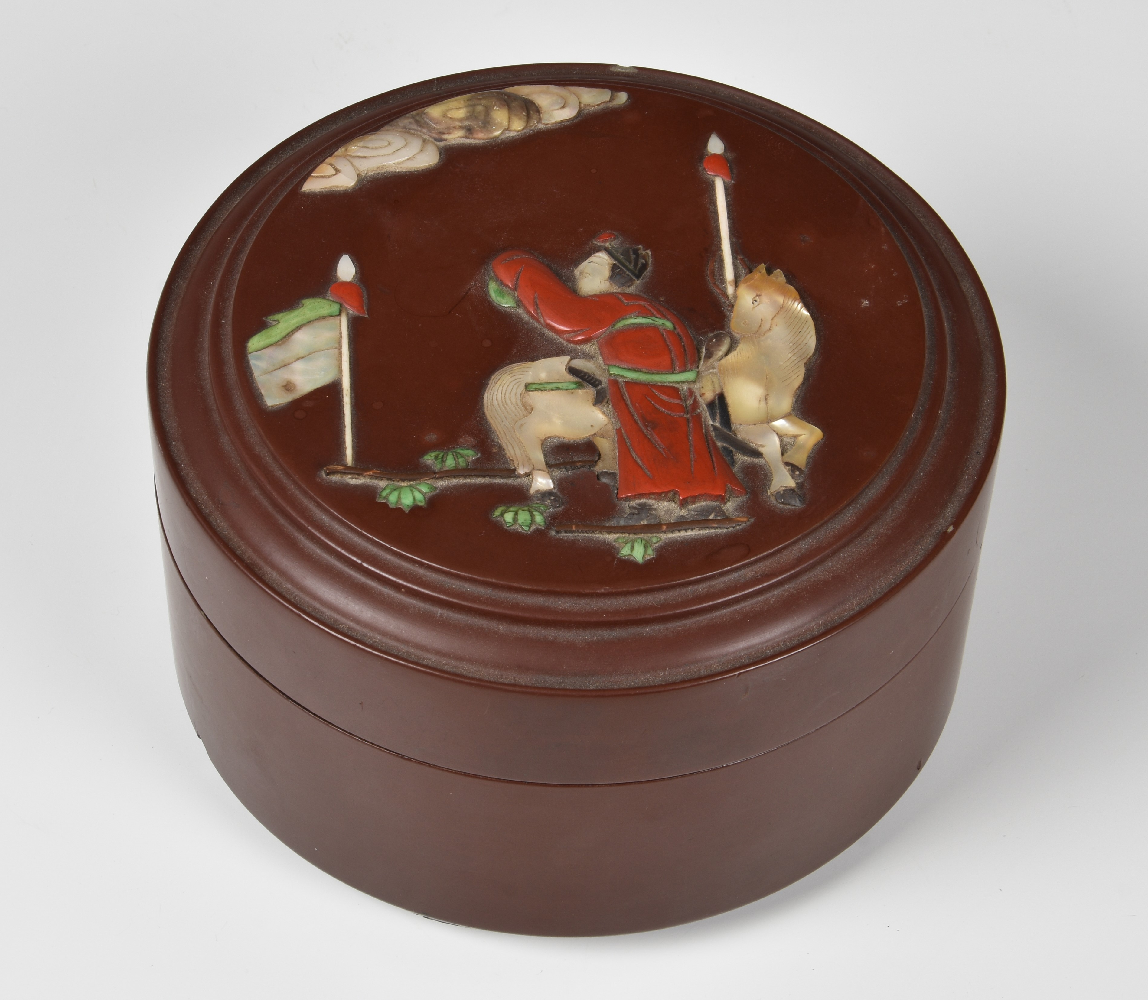A Chinese lacquer box and cover, probably early 20th century, circular, the cover applied with
