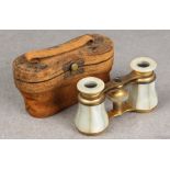 A pair of Victorian opera glasses, brass and mother of pearl in original fitted leather case.