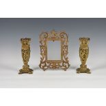 A pair of Aesthetic Movement reticulated brass vases, of tapering square form, decorated with putto,
