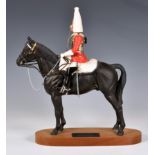 Beswick Porcelain Life guard on Horseback, on a wooden stand. Beswick mark on underside of horse.