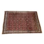 A Hamadan wool rug, North West Iran, 20th century, on red ground with Herati pattern, 117 x 82in. (