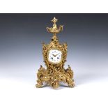 A large French gilt brass rococo revival mantel clock, early 20th century, the signed twin train