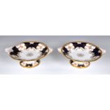 A pair of English Coalport tazzas, of shaped circular form with twin moulded handles, royal blue and