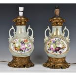 A pair of 19th century porcelain vase lamps, probably French, the stout, baluster vases in a celadon